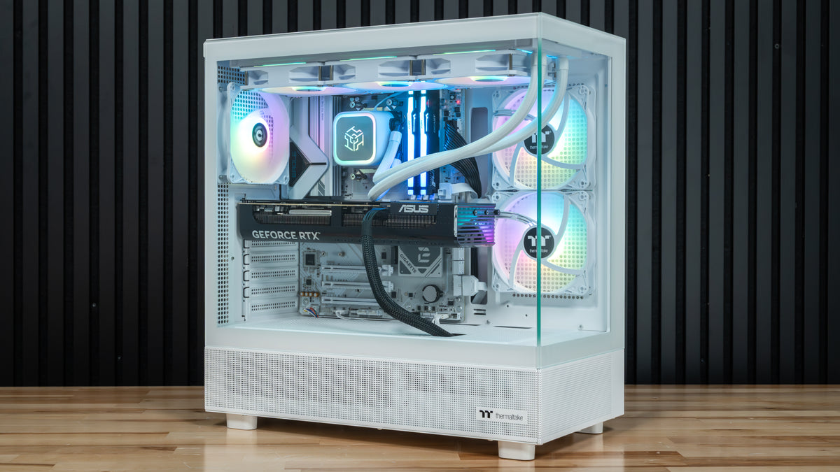 PowerGPU Aurora RTX 5080 gaming PC, white case with RGB lighting on a wood floor