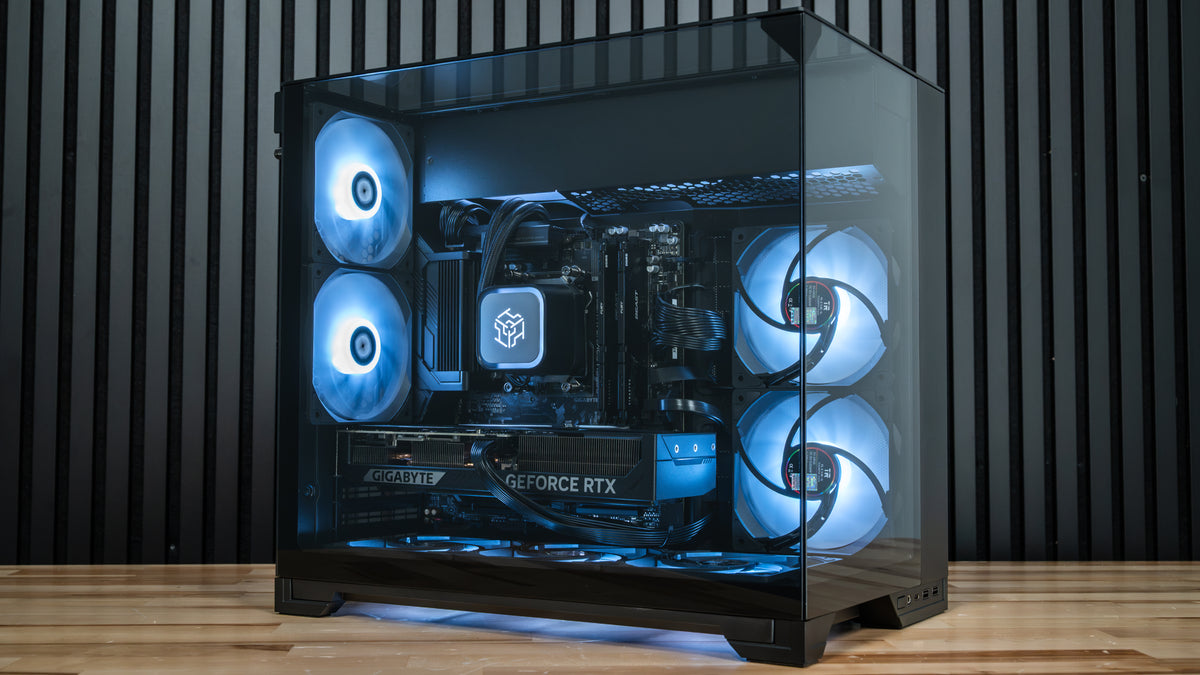 PowerGPU Nox RTX 5070 gaming PC, black case with blue LED fans on a wood surface