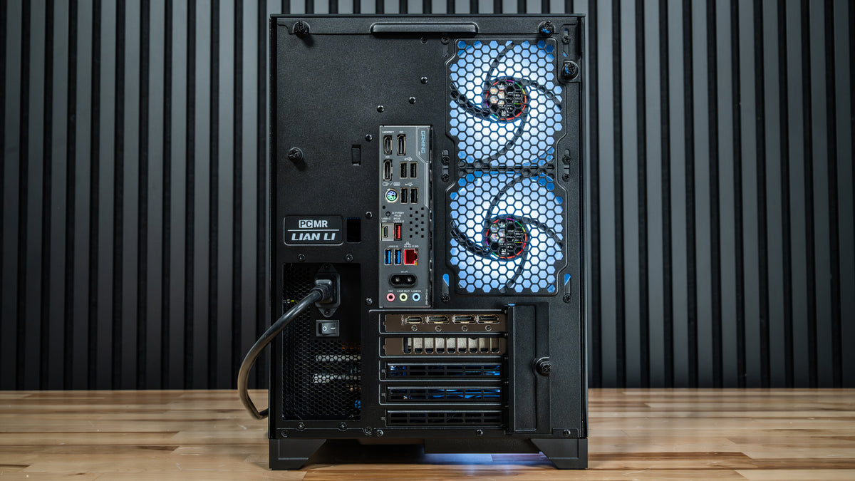 Rear view of the PowerGPU Nox RTX 5070 gaming PC in a Lian Li case on a wood floor