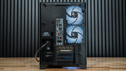 Rear view of the PowerGPU Nox RTX 5070 gaming PC in a Lian Li case on a wood floor