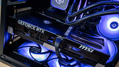 MSI GeForce RTX 5090 graphics card with 16-pin power cable installed in the PowerGPU Azul gaming PC, lit by blue ARGB bottom fans