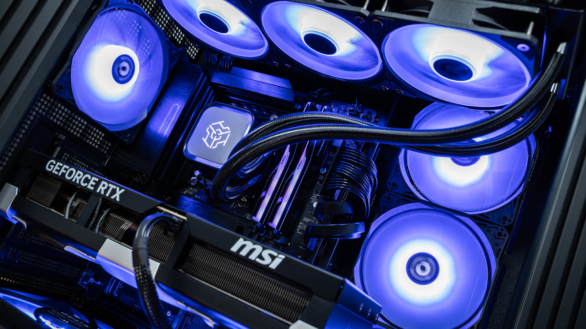 Close-up inside the PowerGPU Azul RTX 5090 gaming PC: 360mm liquid CPU cooler, RGB DDR5 memory, blue ARGB fans and MSI GeForce RTX 5090 graphics card