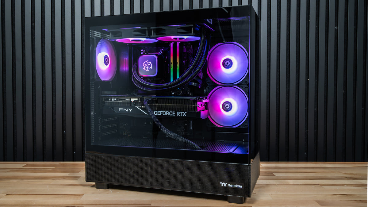 Night Hawk gaming PC front view showing tempered glass, RTX 5070 Ti graphics card, 240mm liquid cooler and purple RGB lighting