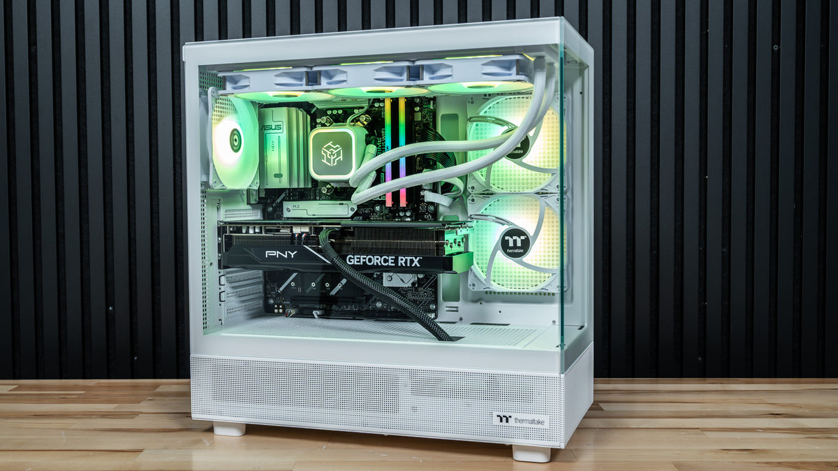 Snow Hawk white gaming PC front view with green RGB fans, tempered glass panels and GeForce RTX 5070 Ti